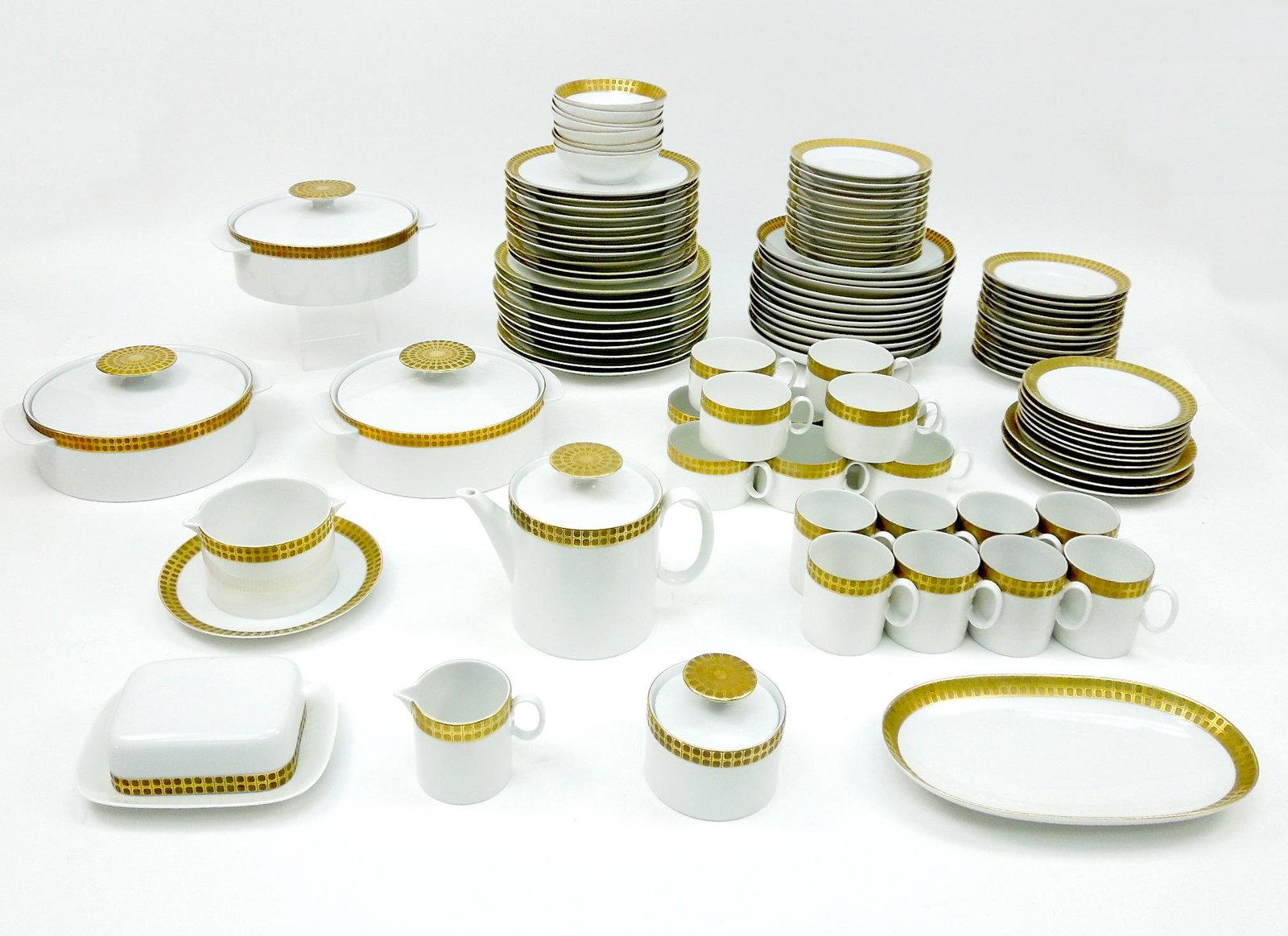 Thomas Porcelain Dinner Service: Thomas, Germany porcelain dinner service, 100+ pieces. Modern design white porcelain with embossed gold rims. Comprising: (10) dinner plates, (11) luncheon plates, (12) soup plates, (3) salad plates, 