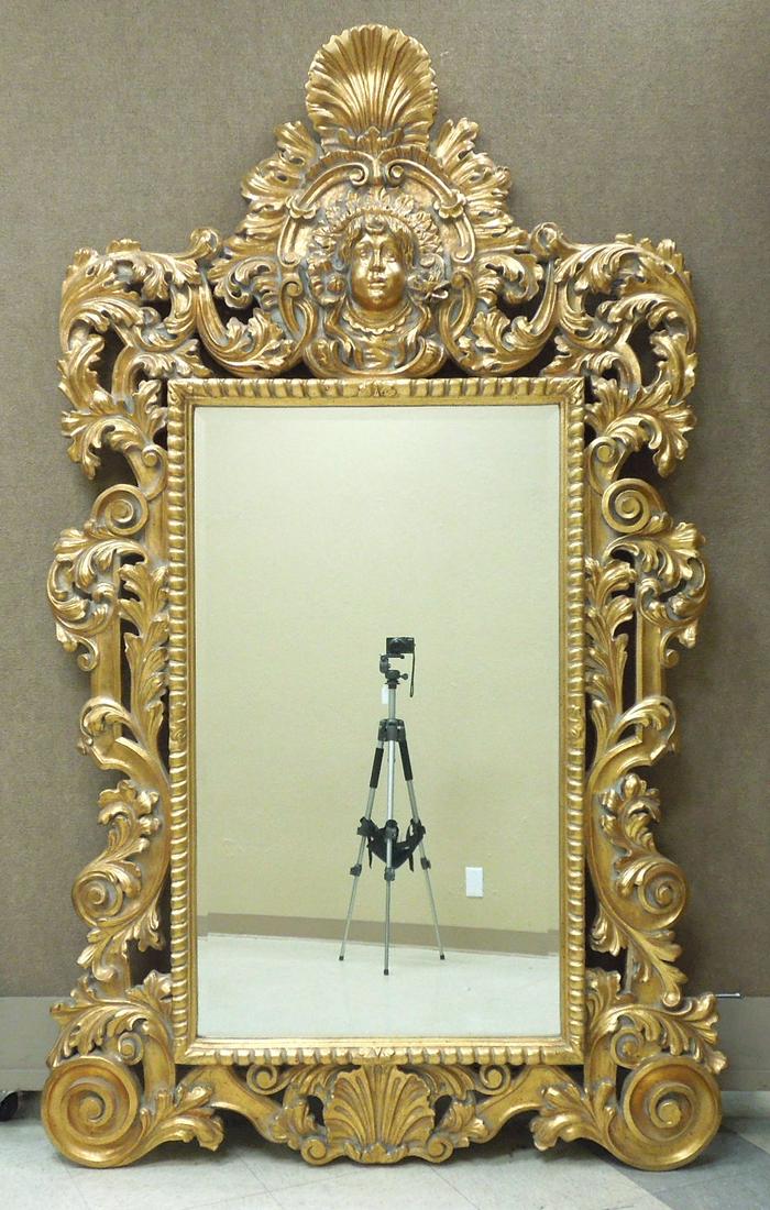 Baroque Style Gilt Framed Mirror.: Decorative Baroque style gilt framed beveled mirror. Ornately modeled with rocaille and mask pediment and acanthine-clad C-scrolls. 80 inches x 50 inches.