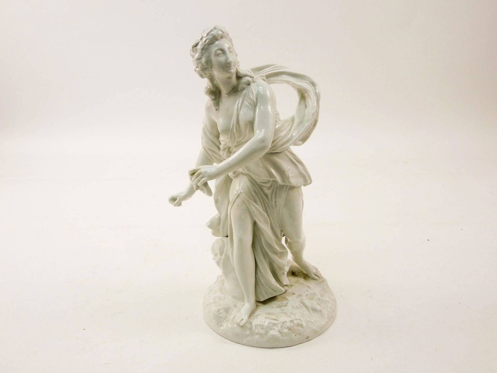 Continental White Porcelain Figure, Lady Holding a: Continental white porcelain figure, lady holding a mask. Blue Crossed Arrows mark. 14" x 7" x 7".