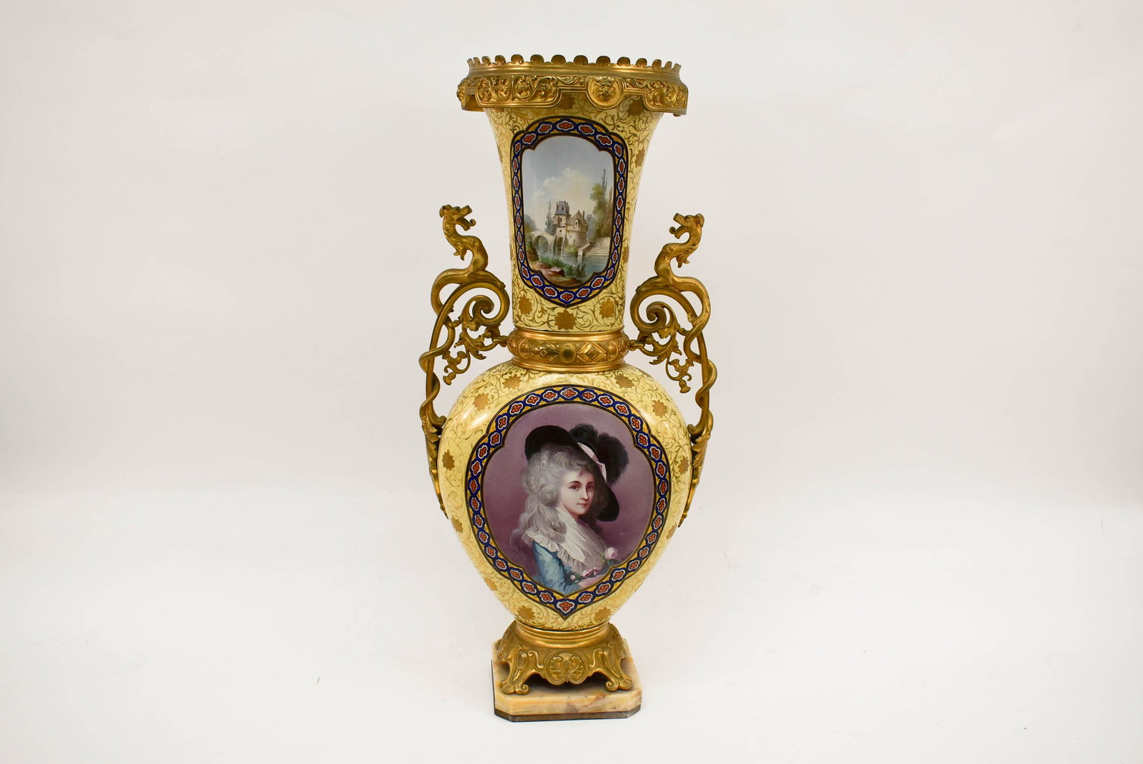 Sevres Style Ormolu Mounted Porcelain Palace Vase.: Sevres style ormolu mounted porcelain palace vase. Hand painted flora and fauna reserves and applied portrait and landscape embellishments. Fitted with gilt metal trailing griffin handles, crown, wais