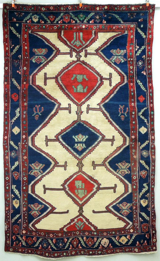 Hand Knotted Oriental Rug.: Hand knotted Oriental rug, wool pile on cotton foundation. Pole medallion on ivory field with indigo and red borders. Like-new condition. Approximately 4ft. 8in x 7ft. 8in.