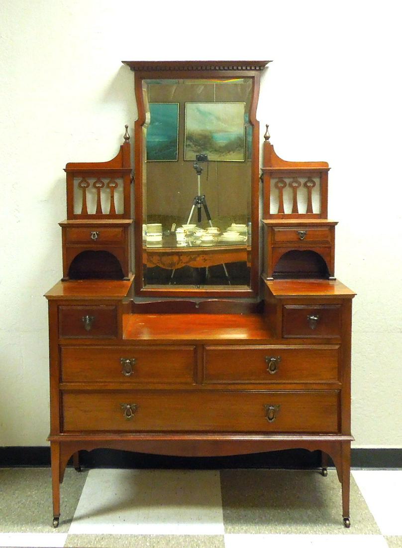 English Edwardian Mahogany Dressing Chest.: English Edwardian mahogany five drawer dressing chest. Recessed center top and gallery fitted with glove drawers at each side of a beveled swing mirror. Circa 1910. 48" L, 22" D, 74" H.