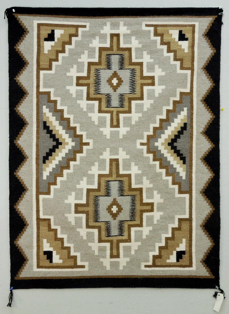 Lucy Begay Navajo Rug.: Lucy Begay Navajo rug. Serrated diamond medallion motif with brown, black and ivory on gray ground. 3'3" x 4'4". With gallery tag.