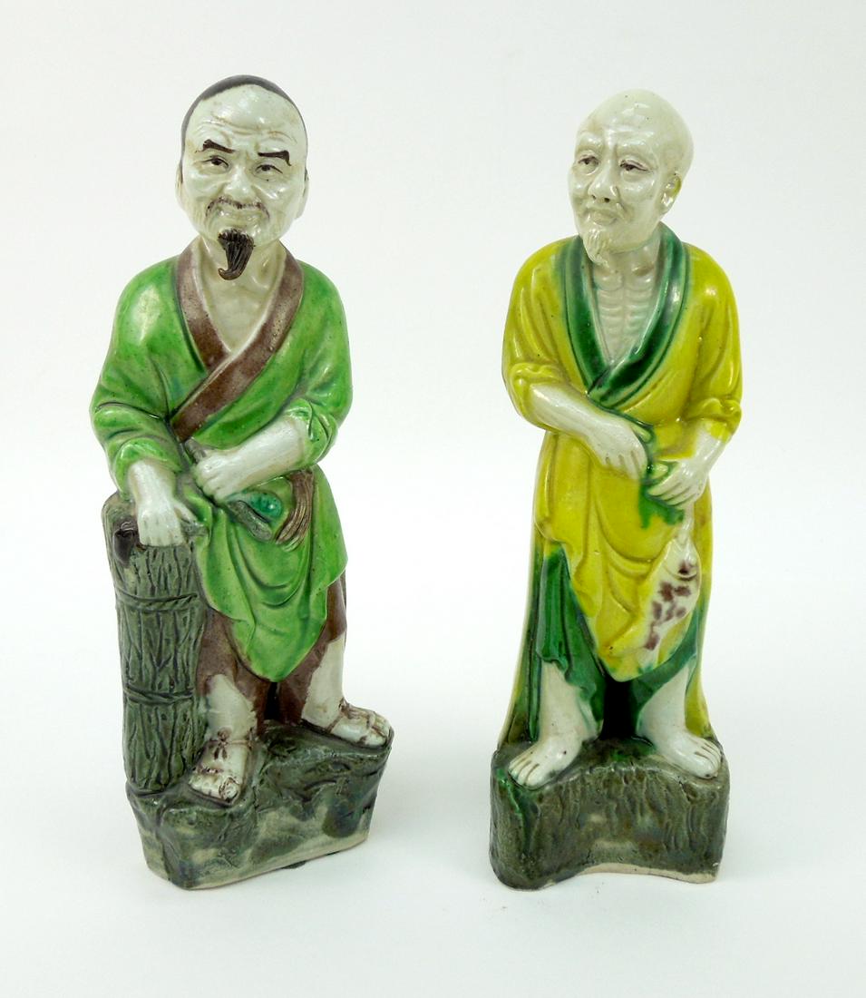 (2) Chinese porcelain Scholar Figures.: (2) Chinese porcelain scholar figures with green and yellow robes. 9 1/4" tall.