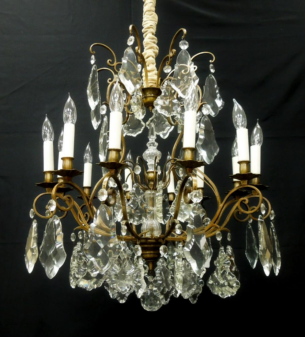 1940s 12-Light Drop Crystal Chandelier.: 1940s 12-light drop crystal chandelier. Brass scroll arms with large drop crystals and crystal ball. 25 x 25 inches, 42 inches tall from ceiling mount to crystal ball.