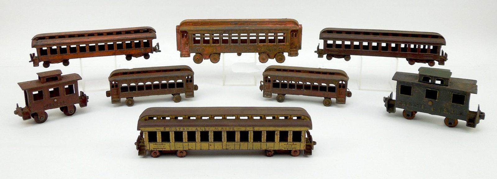 (8) Antique Cast Iron Toy Train Carriages.: (8) Antique cast iron toy train carriages. 6 Passenger cars and 2 caboose.