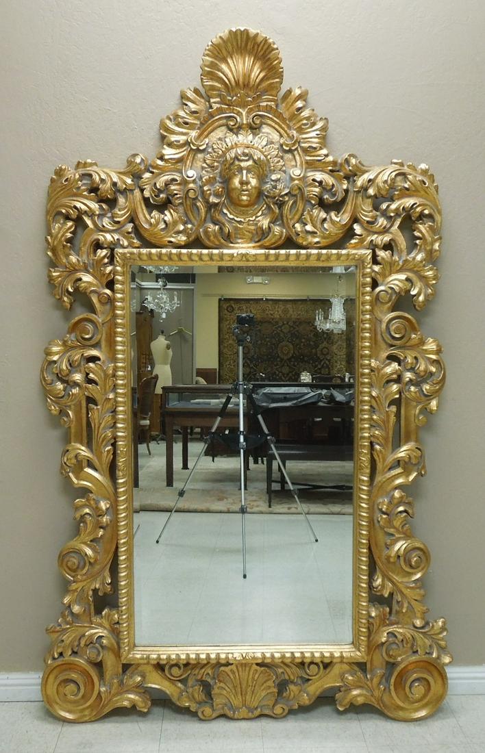Baroque Style Gilt Framed Mirror.: Decorative Baroque style gilt framed beveled mirror. Ornately modeled with rocaille and mask pediment and acanthine-clad C-scrolls. 80 inches x 50 inches.