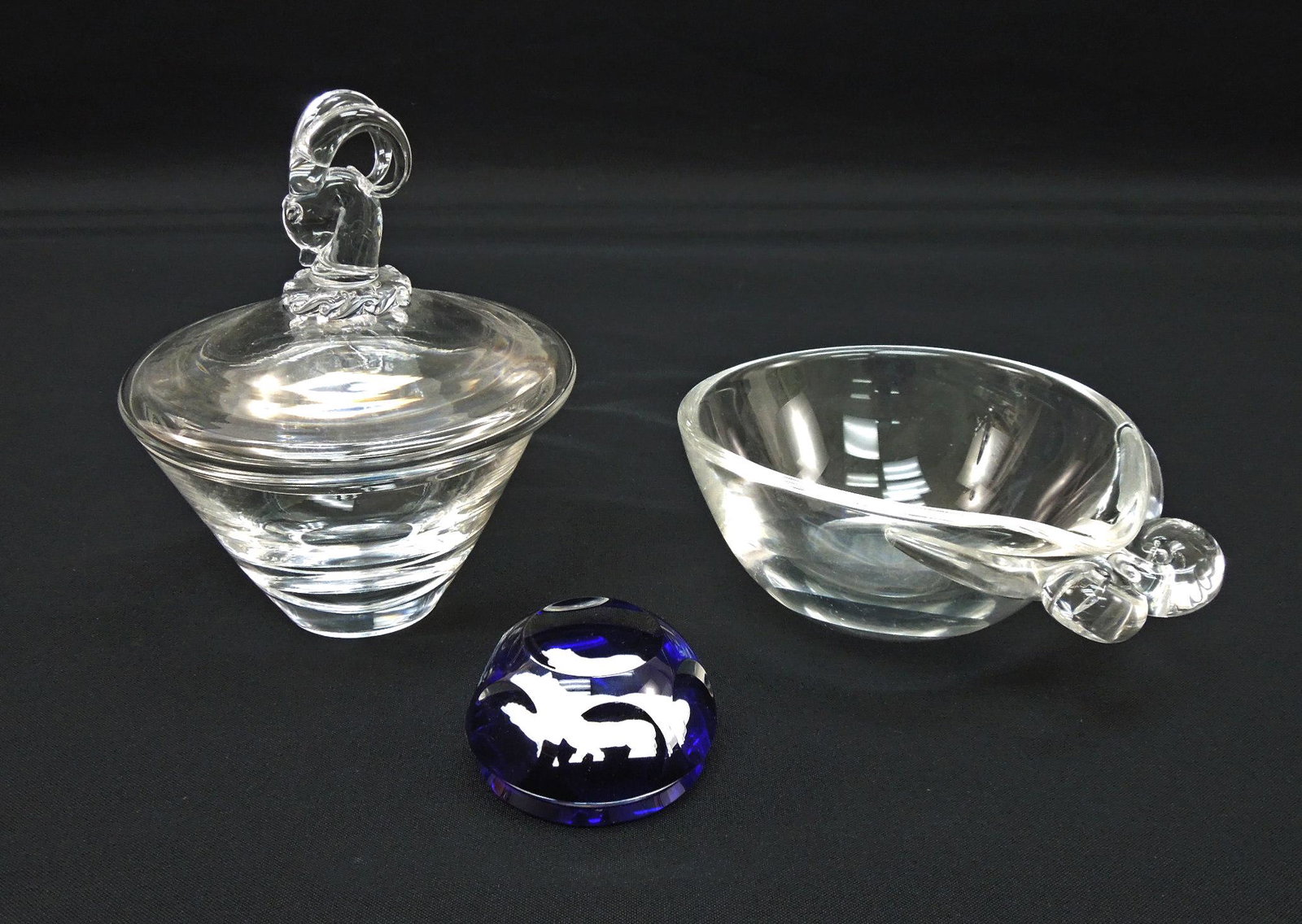 (3) Steuben & Baccarat Crystal Items.: Group of (3) crystal tableware items. Steuben Ram's head candy dish (6.5" tall), Steuben double snail handle bowl and Baccarat Taurus The Bull paperweight.