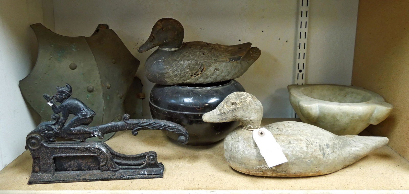 Duck Decoys and Other Vintage Collectibles.: A group of vintage collectibles, including wood and plastic duck decoys, a marble pestle, a cast iron tobacco cutter, and others.