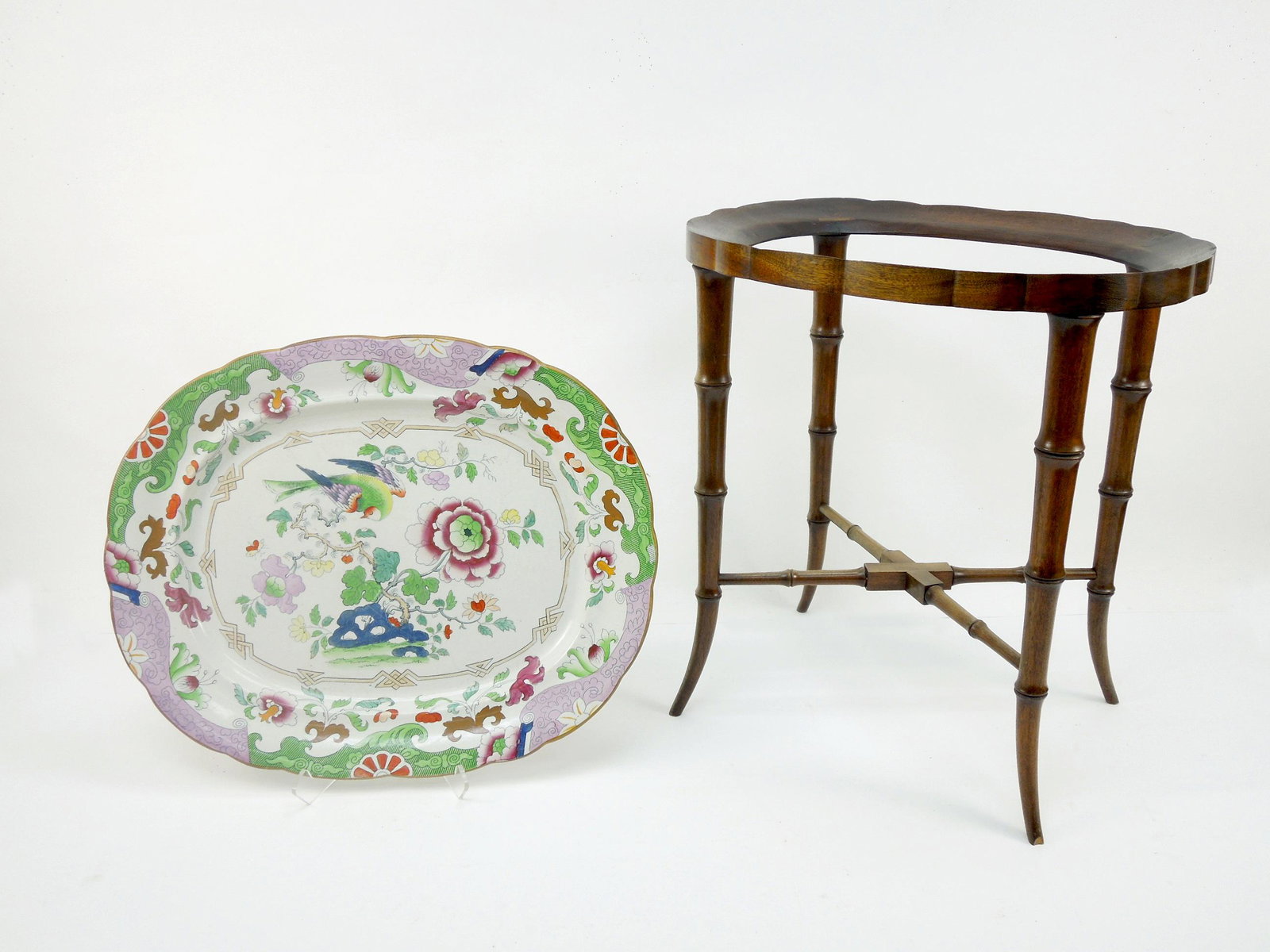 19th C. English Ironstone Charger on Stand.: 19th C. English ironstone charger on stand. British Lion and Unicorn coat of arms. Marked Real Ironstone. Oriental theme with flowers and bird. On a fitted stand. 20 1/2" x 16 3/4", 21" tall overall.