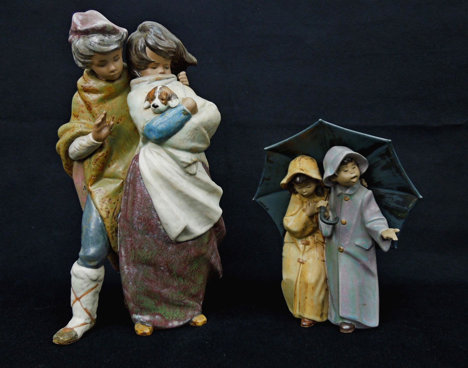 (2) Lladro Gres Figures, Facing the Wind, Under the: (2) Lladro Gres figures, Facing the Wind, Under the Rain. 14 1/4" 7 9 1/2" tall.