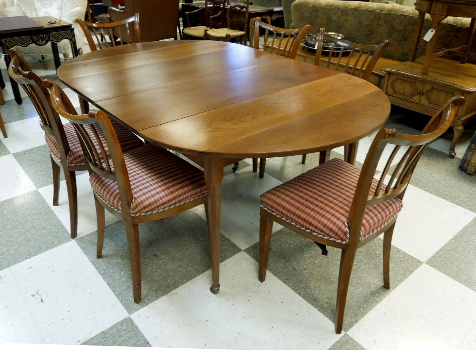 Baker Cherry Wood Dining Table with 7 Oak Chairs.: Baker Furniture cherry wood drop leaf dining table with 3 leaves and (7) early 20th C. Oak dining chairs. Table: 29" tall, expandable from 22" x 47" to 88" x 47".