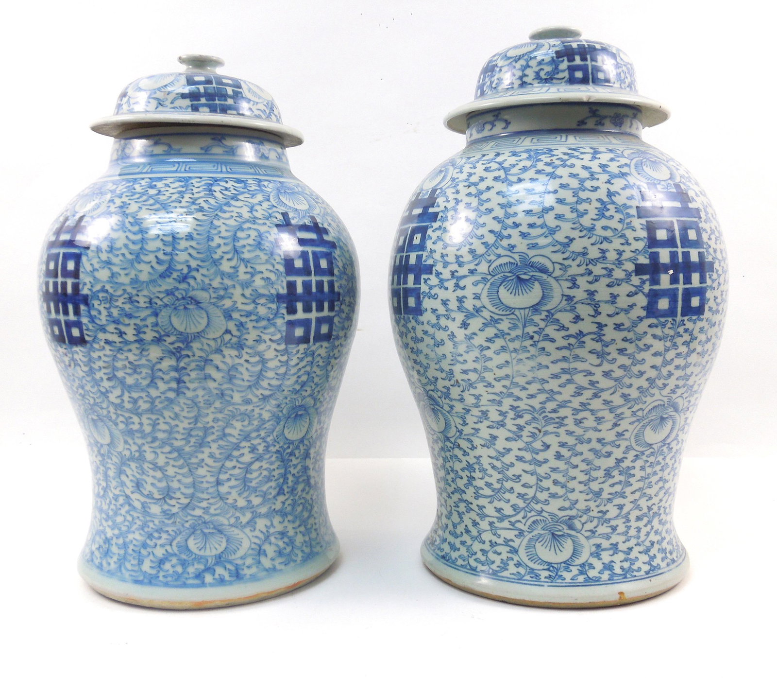(2) Chinese Porcelain Blue & White Ginger Jars.: (2) Chinese porcelain blue and white ginger jars. Overall floral and symbol decoration with lids. Blue 4-character marks on base. 17 & 16 1/2 inches tall.