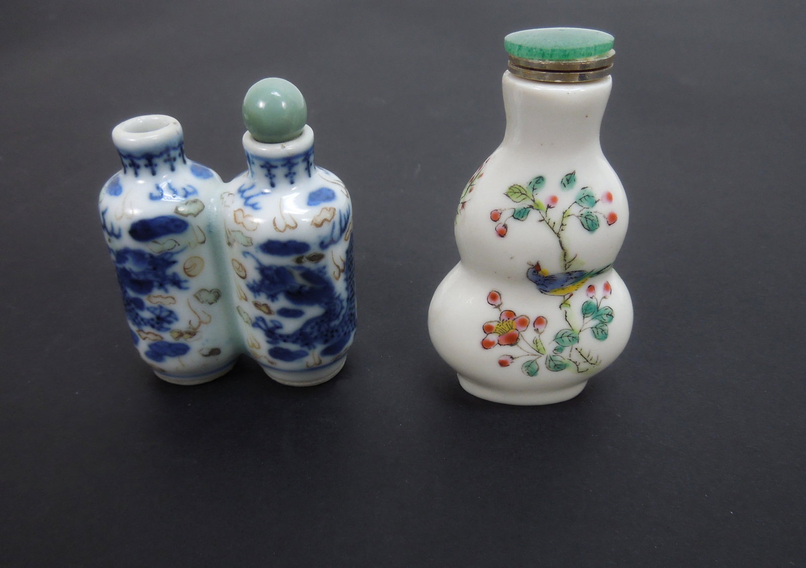 (2) Chinese Porcelain Snuff Bottles.: (2) Chinese porcelain snuff bottles. Blue and white porcelain twin bottle (missing stopper) and a polychrome bottle (Republic, Qianlong mark). Stoppers not original. 2 1/8 and 2 3/4 inches tall.