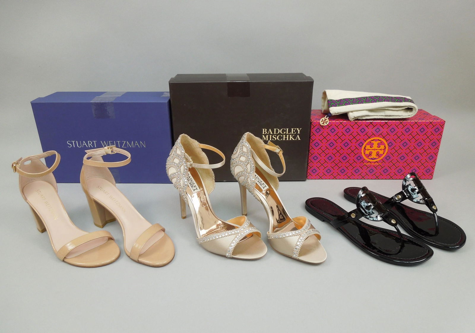 (3) Pairs of Women's Designer Shoes.: (3) Pairs of Women's designer shoes. Stuart Weitzman Nearly Nude Adobe Aniline (size 6), Badgley Mischka Roxy Nudsat (size 9), Tory Burch Sandals (size 8). Unused, with boxes.