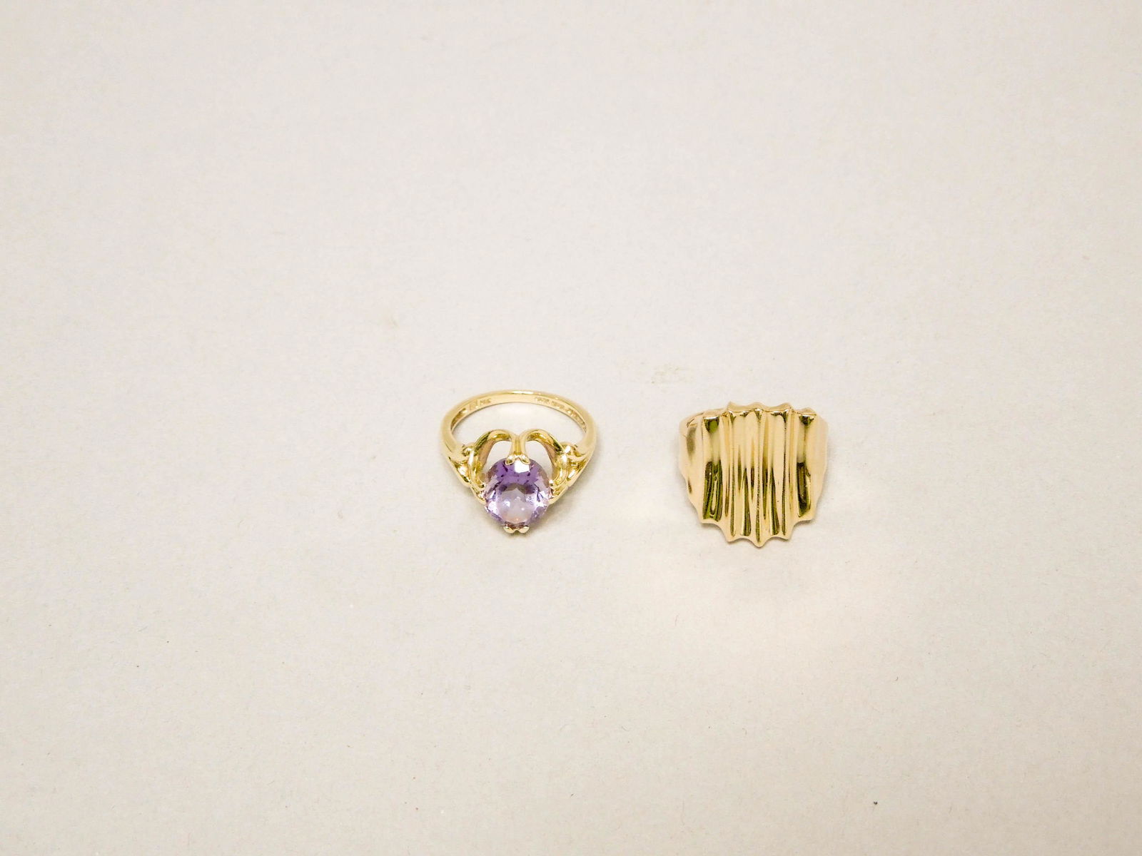 (2) 14K Yellow Gold Rings.: (2) 14K Yellow gold rings, one with faceted amethyst style stones. 5.9 grams total. Sizes 6 & 6 1/2.