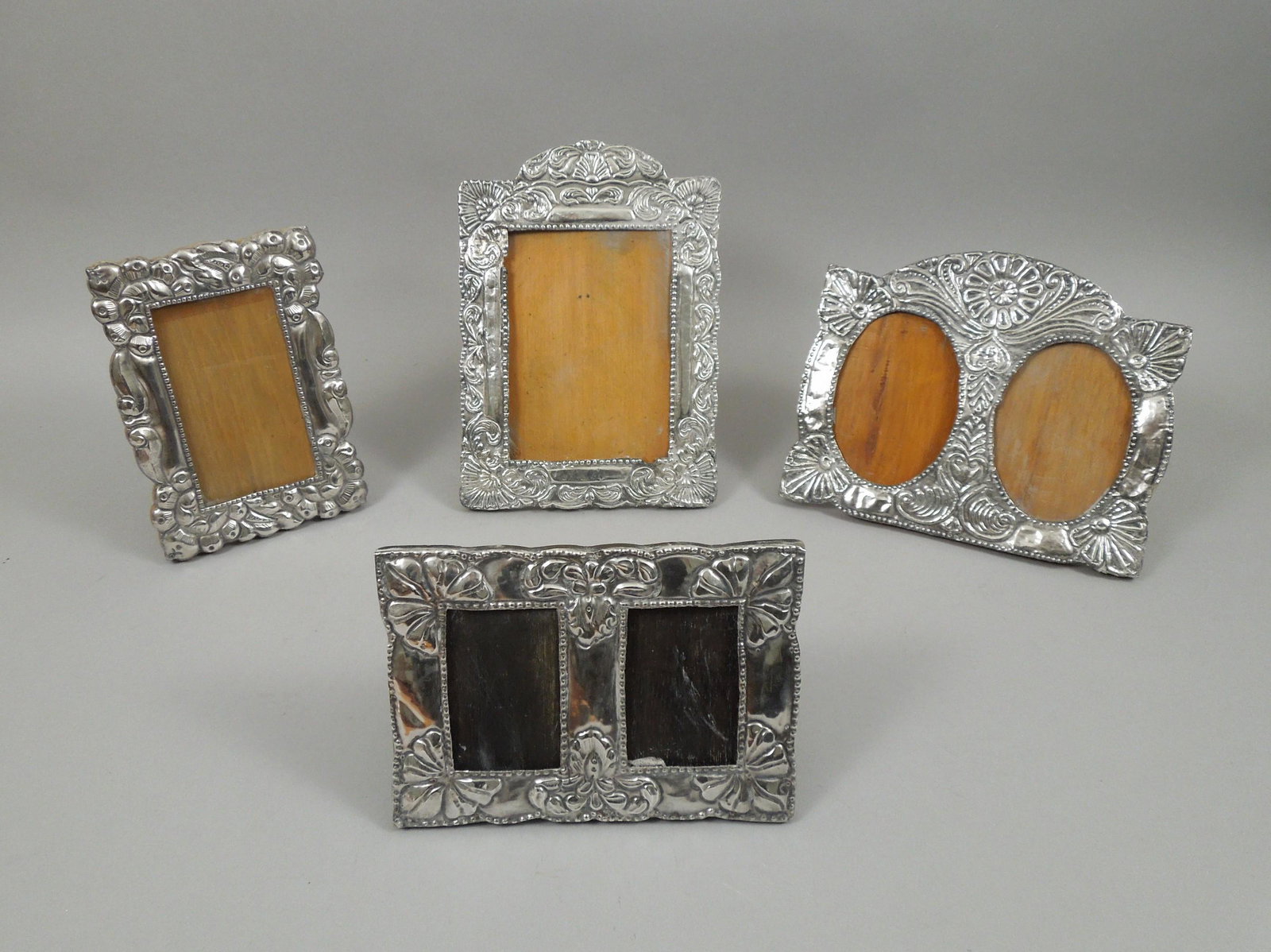 (4) Peru Sterling Silver Picture Frames.: (4) Peru Sterling Silver hand worked picture frames. Two double and two single frames. Largest: 10 1/2 x 7 1/2 x 1/2 inches.