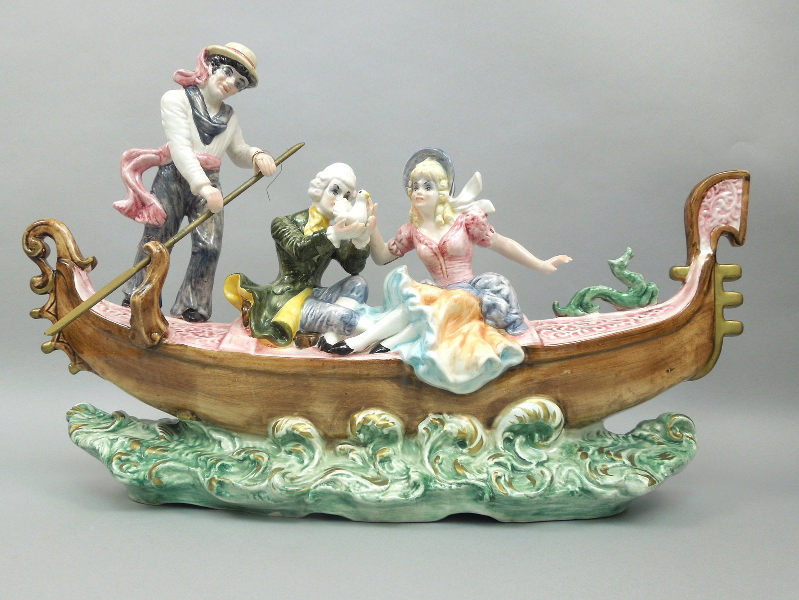 Capodimonte Porcelain Figural Group.: Capodimonte porcelain figural group. Boat ride with man and woman. Man holding a dove. Approx. 26 x 8 x 17 inches.