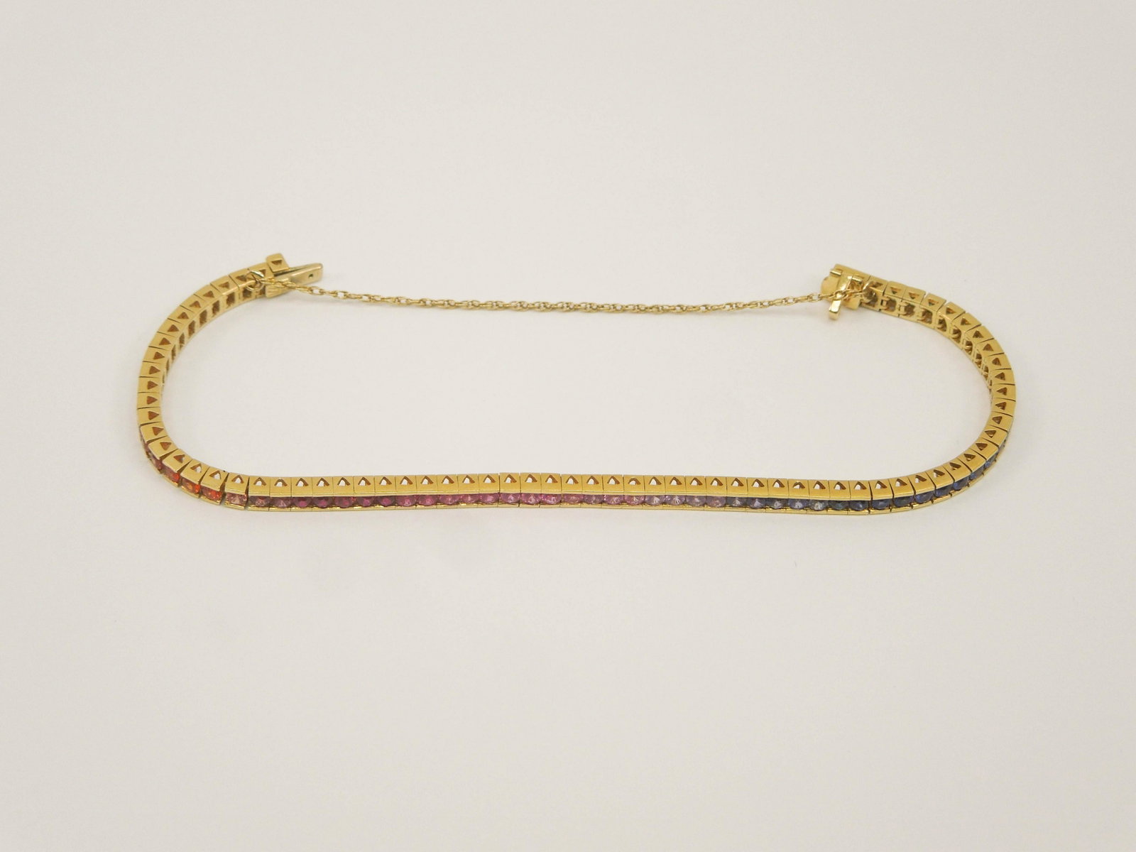 18K Yellow Gold Bracelet with Multicolor Stones.: 18K Yellow Gold bracelet with approximately 70 multicolor stones. Internal diameter: approx. 2 3/8 inches. 16.1 grams total.