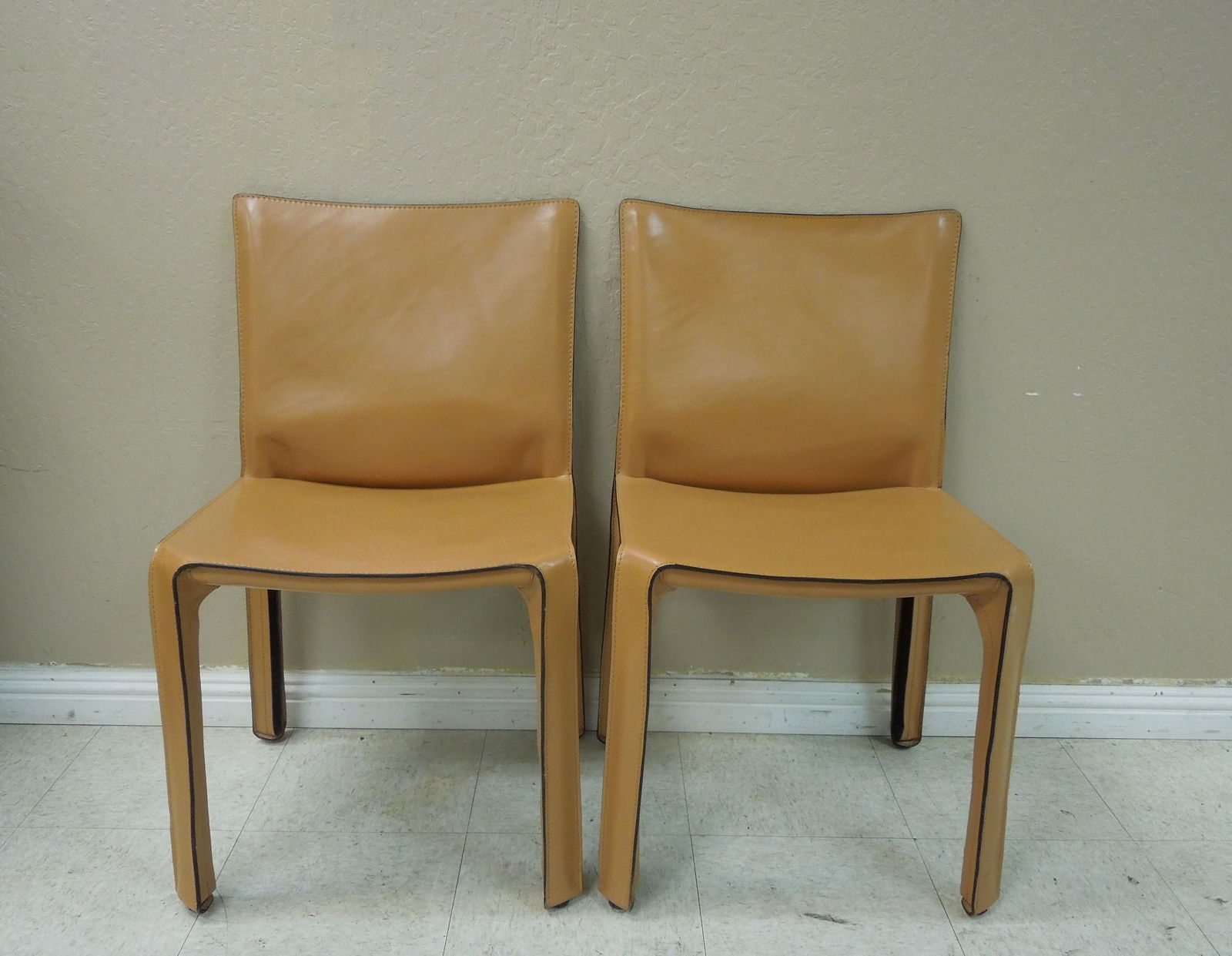 Pair of Cassina Cab Leather Chairs.: Pair of Cassina leather side chairs, Cab 412 petite style. 18.5" W, 16.5" D, 32.5" H.