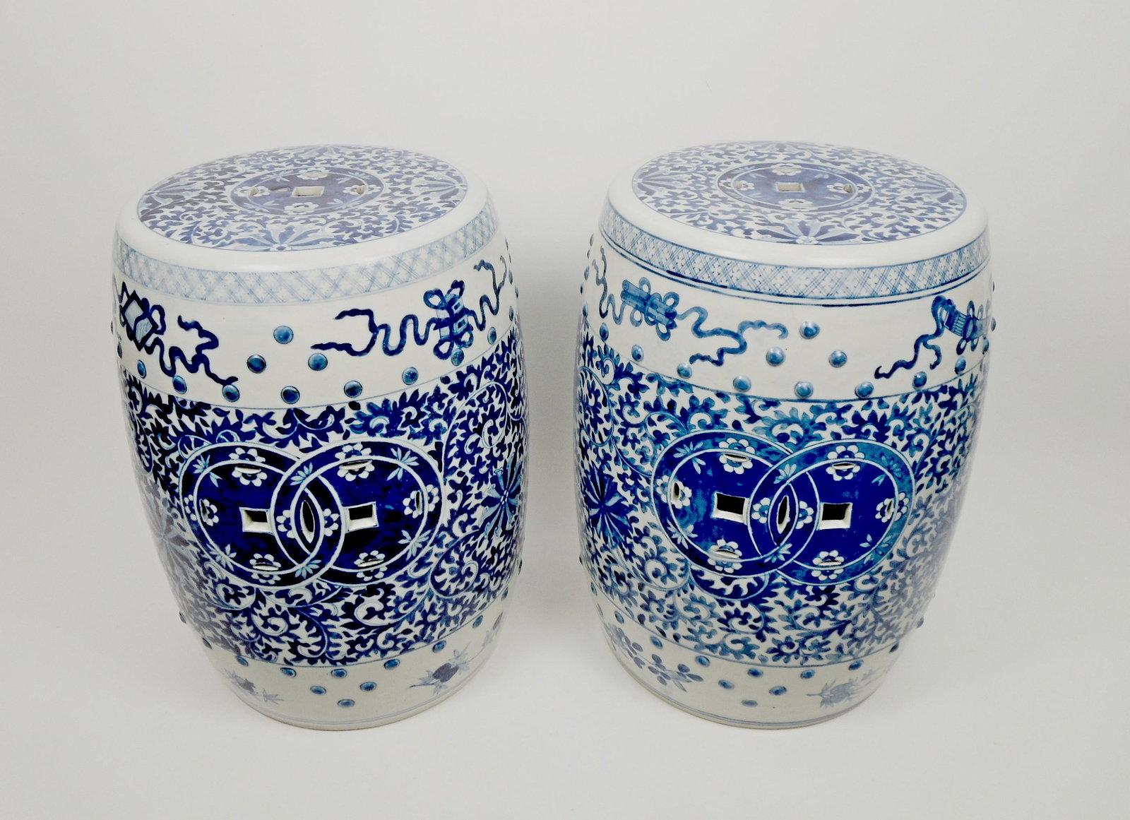 Pair of Chinese Porcelain Blue & White Garden Seats.: Pair of Chinese porcelain blue and white garden seats. One with 4 character mark. 19 inches tall, 13 inches diameter.
