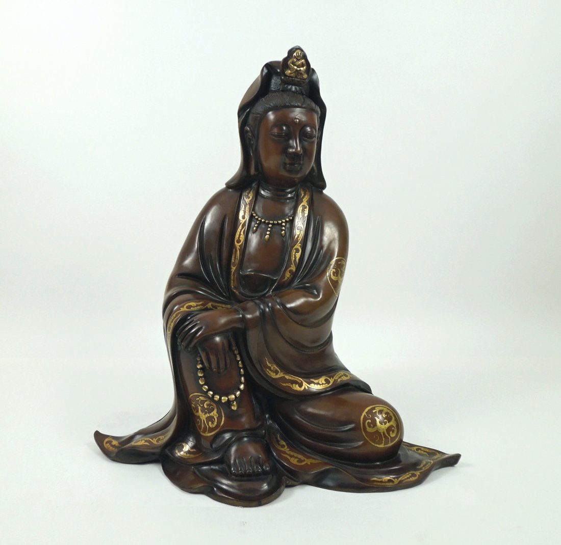 Cast Bronze Bodhisattva Sculpture.: Cast bronze Bodhisattva sculpture, 20th C. Heavy bronze figure seated with right knee raised with right palm resting on leg, supporting left crossed arm. The brown robe has a border of scrolling gold 