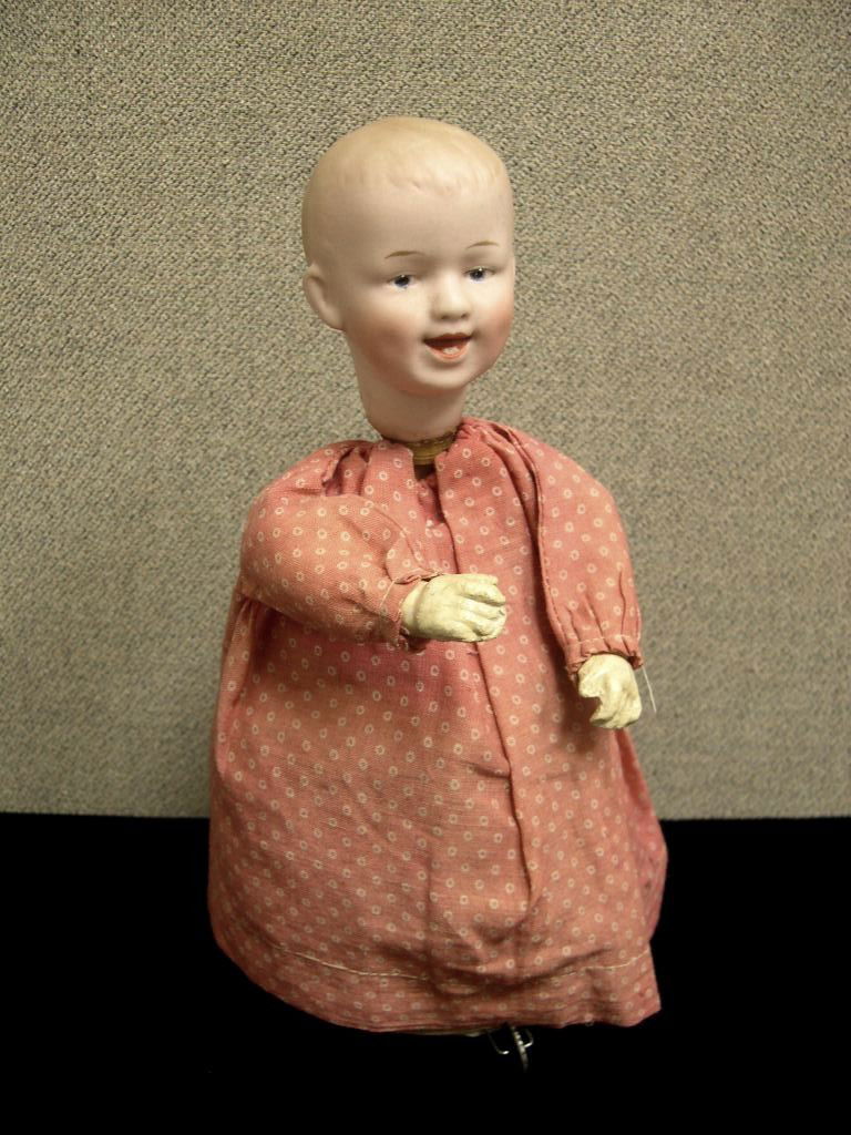 Laughing Gebruders Heubach wind-up doll #7604: Laughing Gebruders Heubach mechanical key wind-up doll #7604. Square mark on neck, bisque socket head has intaglio blue eyes, open/closed mouth with two molded teeth, molded and painted hair, compo