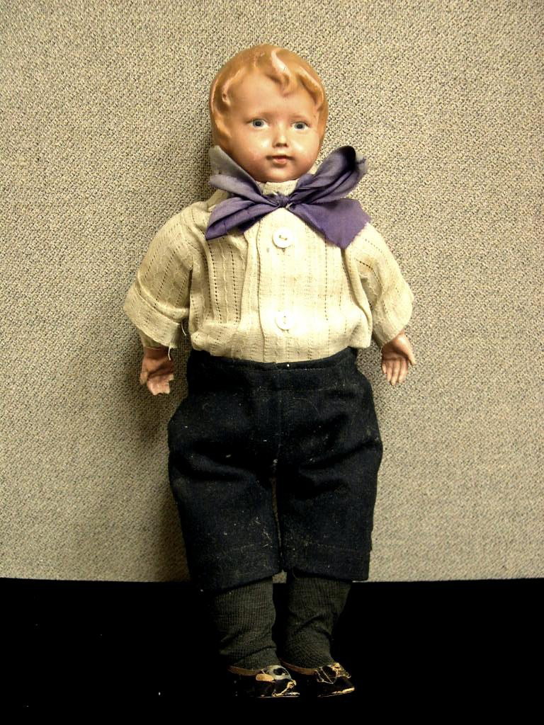 Circa 1910 American composition doll: American composition doll. Composition flange head and hands, molded and painted hair, painted facial features. Cloth body, firmly straw stuffed. Antique garments, socks and shoes. Height: 13 inches C
