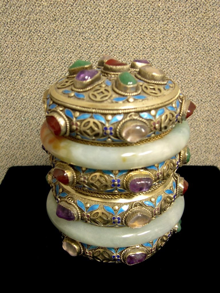 Chinese Silver and Enameled Tea Caddy: Chinese Silver and Enameled Tea Caddy with jade and enamel accents, the cylindrical body composed of six horizontal bands, the second and fifth band formed by jadeite bangles, above three silver filig