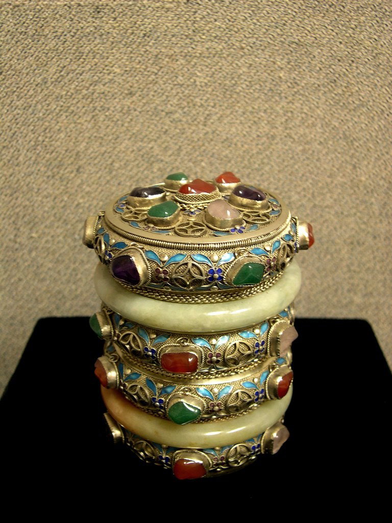 Chinese Silver and Enameled Tea Caddy 4": Chinese Silver and Enameled Tea Caddy with jade and enamel accents, the cylindrical body composed of six horizontal bands, the second and fifth band formed by jadeite bangles, above three silver filig