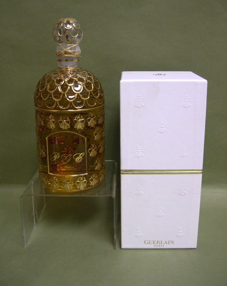 Guerlain Gilt “MITSOUKO EDT, 1,000ml/34 fl.oz: An oversize bottle of Guerlain, Paris “MITSOUKO” Eau de Toilette 1000ml/34 fl.oz. the bottle decorated with a gilt-gold bee pattern, sealed and in original box. Label underfoot numbered "025102".