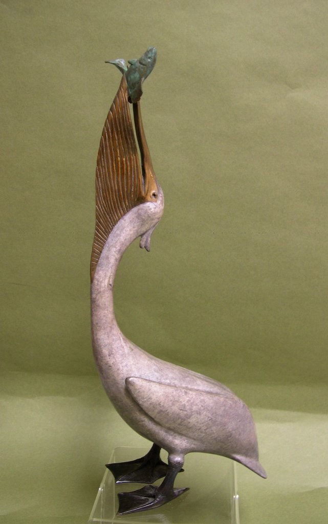 Brian Arthur Tall Bronze Pelican with Fish #49/85: Brian Arthur naturalistic bronze of a Pelican with fish in its beak, Limited Edition sculpture, signed by the British Artist, “Arthur 49/85”. Size: 16 ½ x 6 ½ x 4 inches