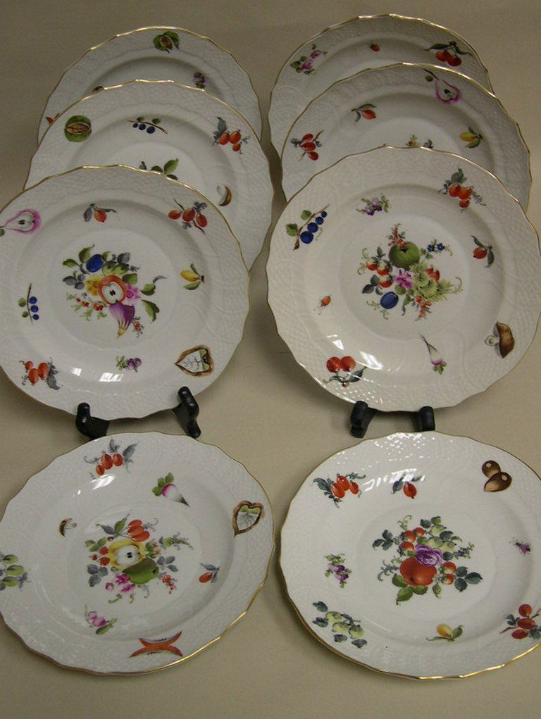 (8) Herend, Hungary Handpainted Porcelain Plates: Herend, Hungary, eight (8) porcelain plates, hand-painted decoration depicting fruits, flowers and ladybugs on a white ground with basket-weave detail. Various blue back stamps, #1518 Diameter: 7 3/8