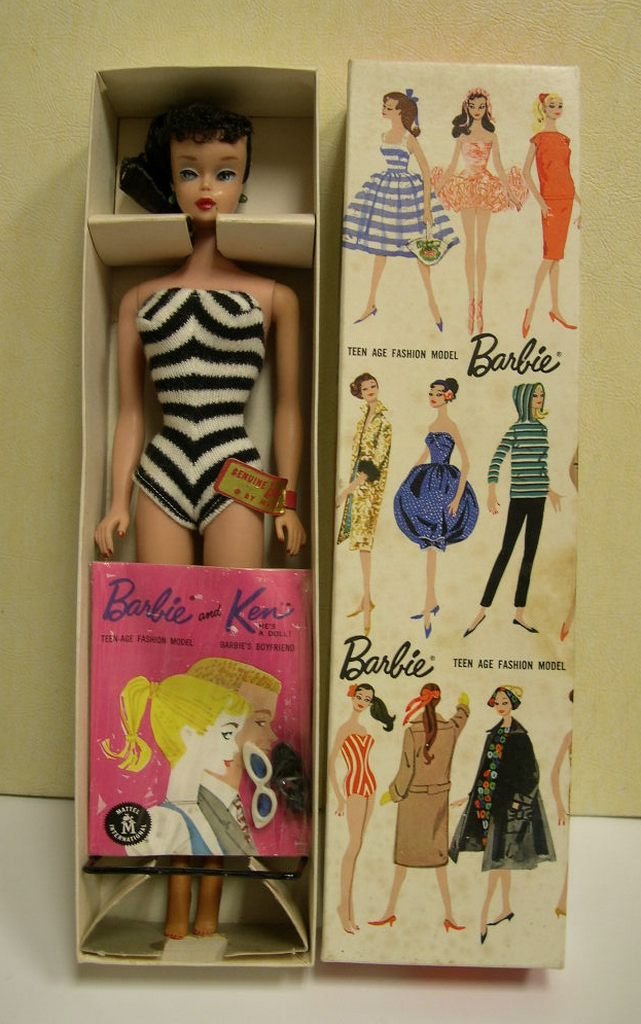 Vintage Brunette Ponytail Barbie # 850 in Box: Vintage Brunette Ponytail Barbie #850 in box, Copyright 1959, with stand and “Genuine Barbie by Mattel” wrist-tag. Brunette hair with ponytail and curly bangs, painted features including blue eyes