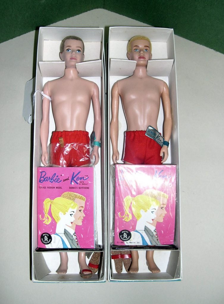 (2) Vintage Ken Dolls No. 750: (2) Vintage Ken Dolls, Stock No. 750; (1) with blonde crew cut hair, blue eyes, (1) with brunette crew cut hair, blue eyes. Both in original boxes with stands. Both with original Mattel wrist labels.