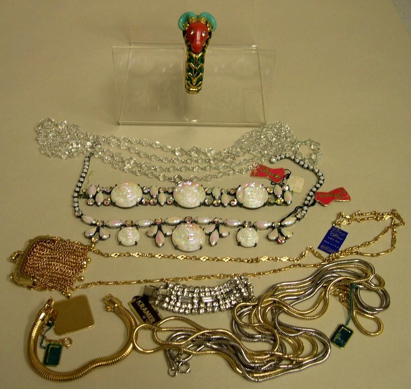 Collection of Mid-20th Century Designer Costume Jewelry: Collection of Mid-20th Century Designer Costume Jewelry. Includes Hattie Carnegie Ram Bangle with enamel, stamped; Schaparilli necklace and matching bracelet with original tags and stamped; Lisner wid