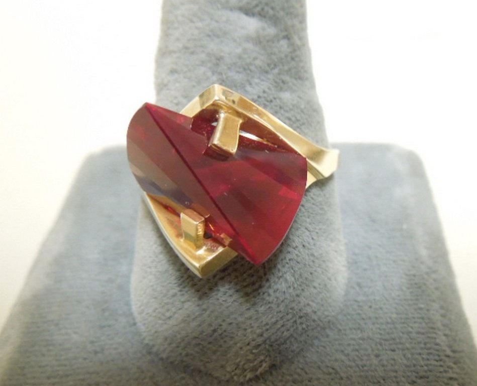 Strell Gold and Ruby Fashion Ring: Lens-cut synthetic ruby in 14kt. yellow gold mounting Ring total weight: 8.1 grams. Size 10.5