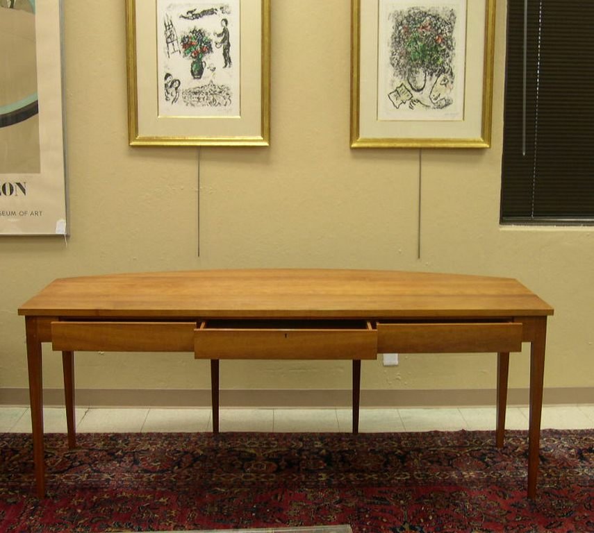 Thomas Moser Bowfront Desk Signed 1992: Thomas Moser Bowfront Desk, Cherrywood, featuring three drawers cut from a solid cherry apron, a lockable center drawer and six tapered legs. Signed underneath: Thos. Moser Cabinetmakers Auburn, Maine