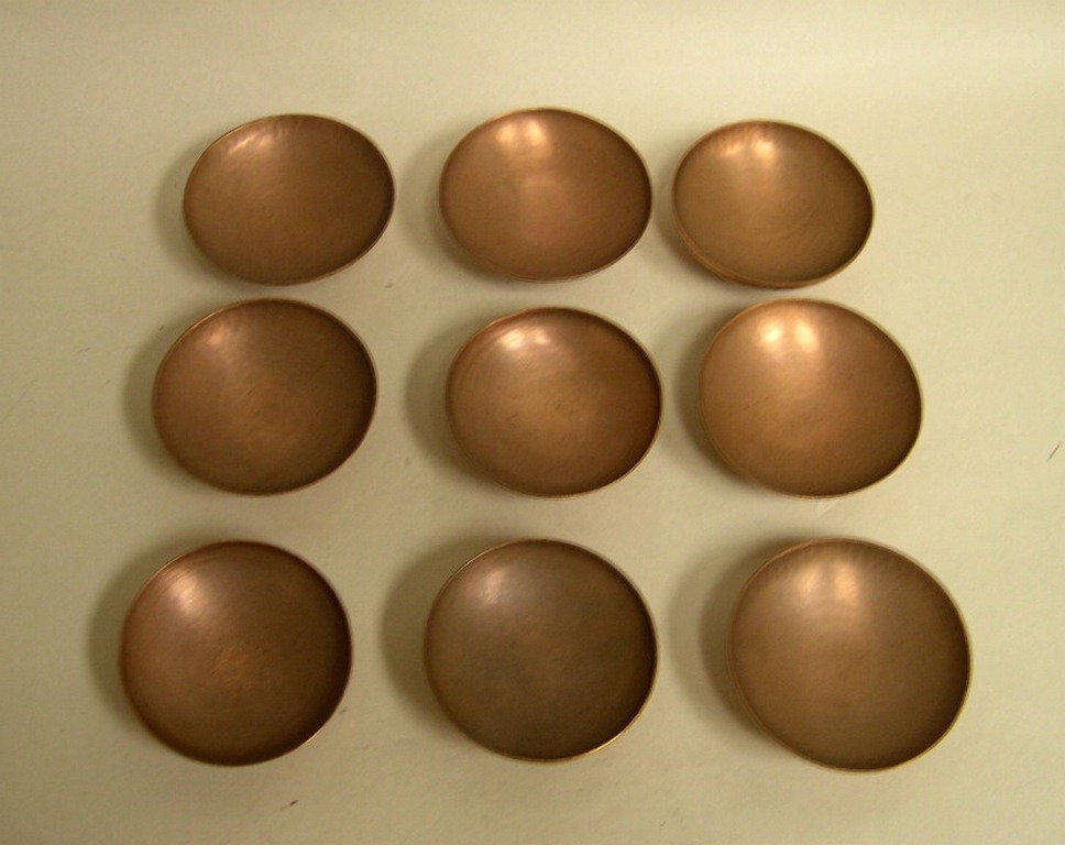 (9) Dirk Van Erp San Francisco Copper Dishes: Nine (9) Dirk Van Erp San Francisco hammered copper dishes, raised on square pilaster base. The interior of the dish is mat, the underside polished. Dirk Van Erp San Francisco Windmill stamp on all di