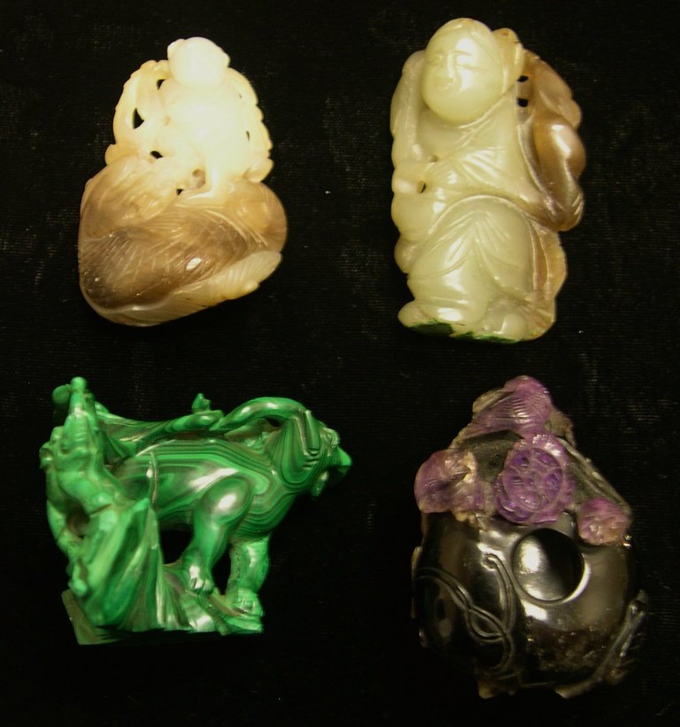(4) Hard Stone Carvings.: Malachite, Purple Quartz and two Soapstone. Length: 2 3/8 inches.