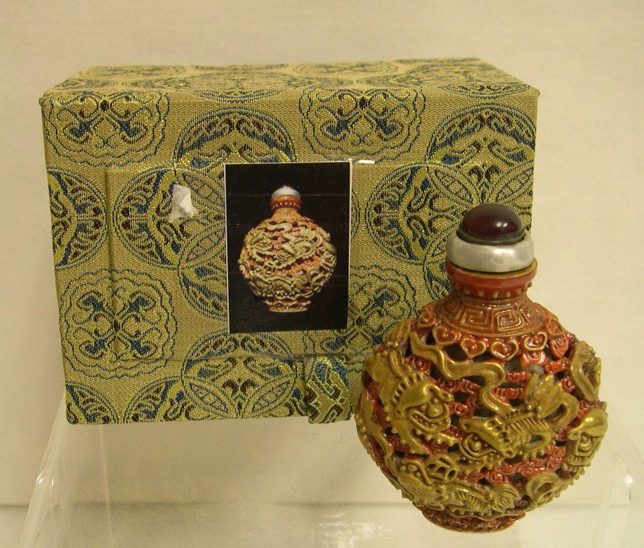 Rare Gilt Porcelain Animals Snuff Bottle: Round bulbous bottle. eight gild Qiling with the red background ruyi, open work, ruby top with silver rim on stopper. A red mark: "Jia Qing Nian Zhi" on base. Height: 2 3/4 inches.