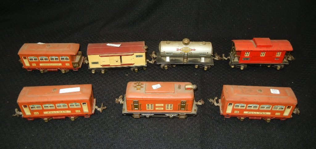 Seven (7) Pre-war Lionel Train Locomotive and Cars: Seven (7) Pieces Pre-war Lionel train cars consisting of No. 248 Locomotive, two (2) No. 529 Pullman cars, No. 530 Observation car, No. 654 Sunoco tanker, No. 655 Box car, and No. 654 Caboose.