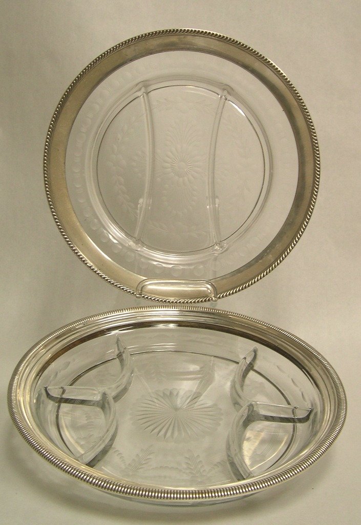 (2) Glass Serving Trays with Sterling Silver Bands: Two Glass Serving Trays with Sterling Silver Bands. Divided servers, etched decoration, one Gorham Sterling Silver rim band, the other Watson & Co. Sterling Silver rim band. Diameter: 12 inches. Stamp