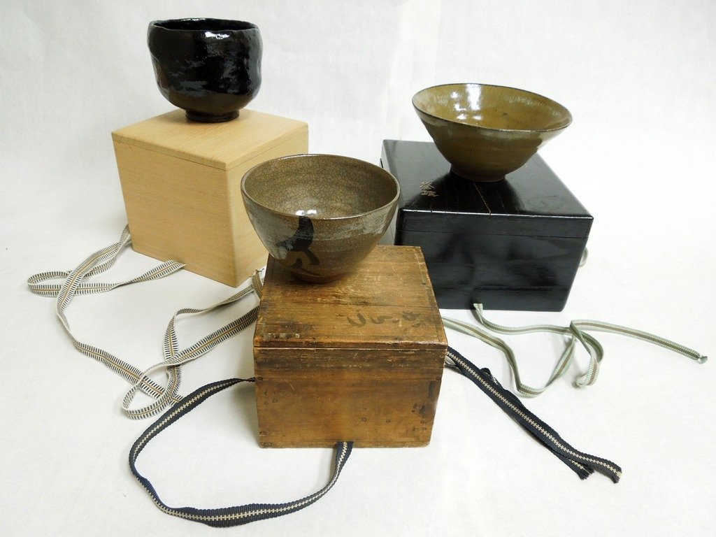 3 Japanese Pottery Cha-wan: A Tomoku pottery glazed cha-wan (tea bowl) with incised stamp; and two other cha-wan, (total 3 tea bowls). Each with its own kiri wood box. Mid 20th Century.