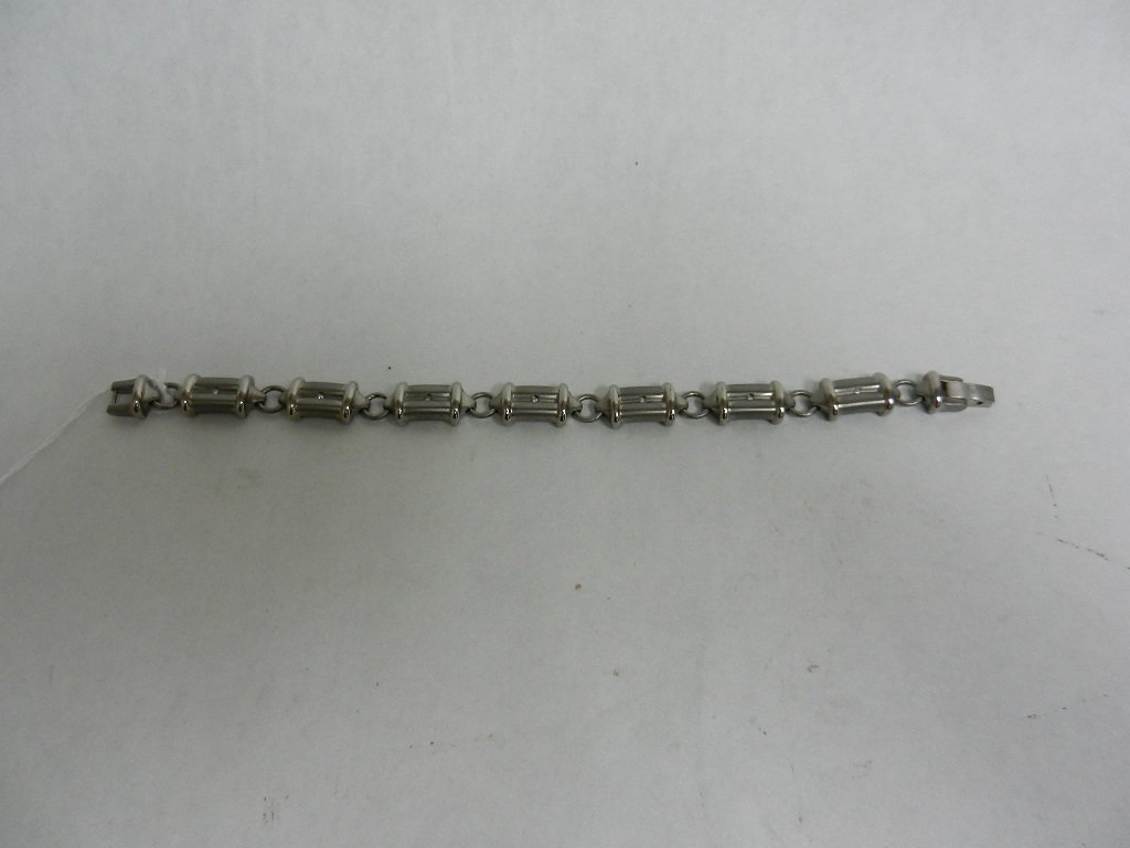 Super Horse Titanium Diamond Bracelet: Brushed titanium link bracelet, each of the seven links centered with a diamond. Marked: Super Horse Titanium Diamond. Length overall: 8 1/2 inches