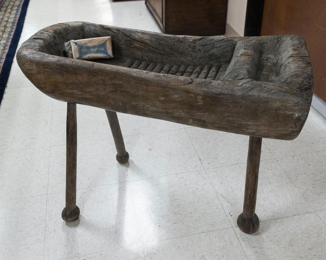 Primitive Native American Baby Bath.: A primitive Native American baby bath, carved from a wood tree trunk and raised on (3) wood legs. (Approx. 23" x 32" x 14").