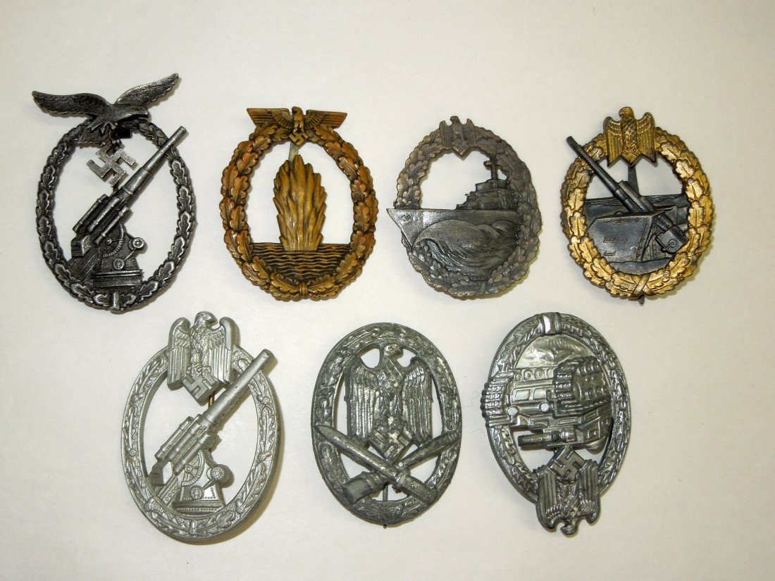 Seven (7) German WWII Military Badges: Seven German WWII Military Badges. Includes General Assault Badge (Allgemeines Sturmabzeichen), silver color, no markings; Panzer Assault Badge(Panzerkampfabzeichen) silver color, marked on back Frank