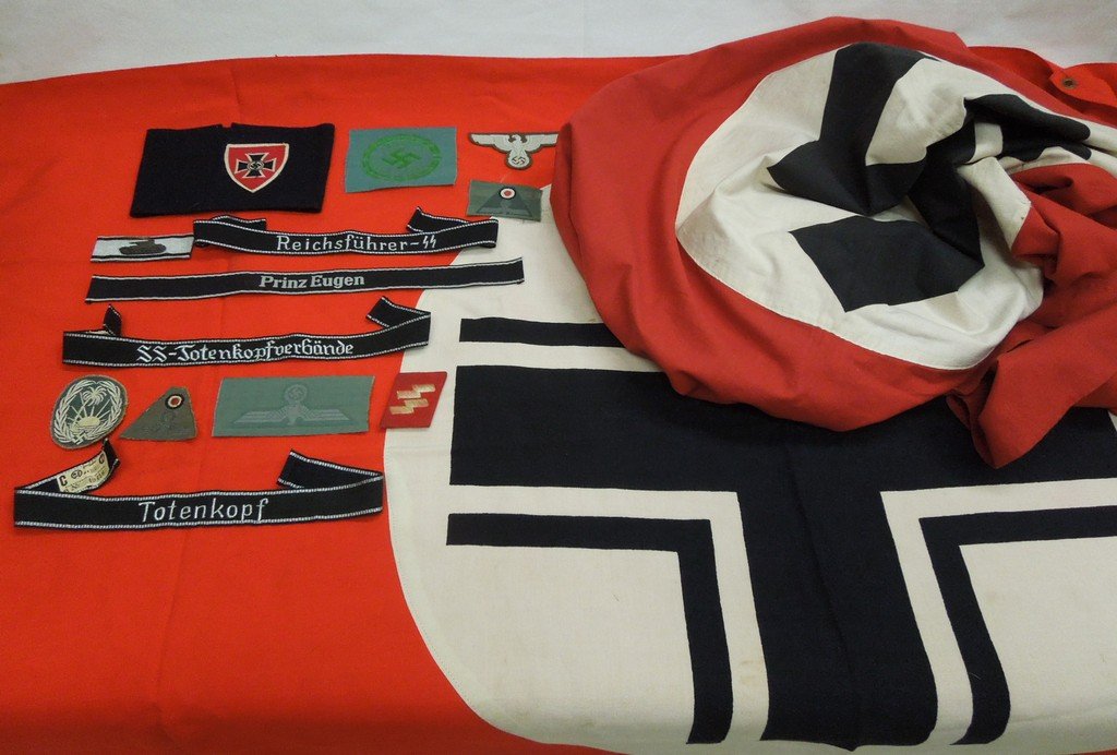 Group of German WW II fabric items: Group of German WW II fabric items. Includes Balken cross vehicle recognition drape (approx. 75 x 35 inches, emblem 26.5 inch diameter); a WW2 German flag (approx. 90 x 44 inches, emblem 28 inch diame