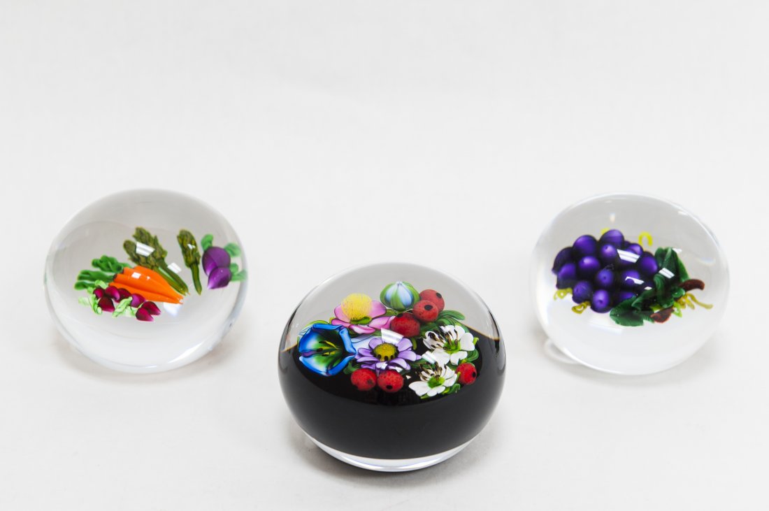 (3) Ken Rosenfeld Art Glass Paperweights.: (3) Ken Rosenfeld Art glass paperweights. Floral spray on dark ground., dated 2000, Display of vegetables, dated 2003 & Grape clusters, dated 2005. (Approx. 2 1/2" x 4", 2 1/2" x 3 1/4" & 2 1/2" x 3 1