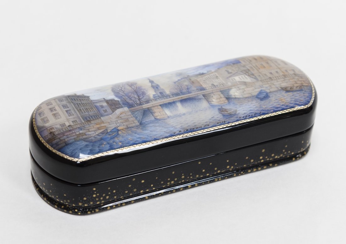 Russian Lacquer Box.: Russian lacquer box. Oblong form, with hinged lid. Hand painted miniature scene. Inscribed and dated at lower edge of the painting. Mother-of-pearl and gilt luminescence. Black lacquered body scattere
